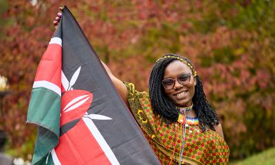 A picture of a person holding a Kenya flag